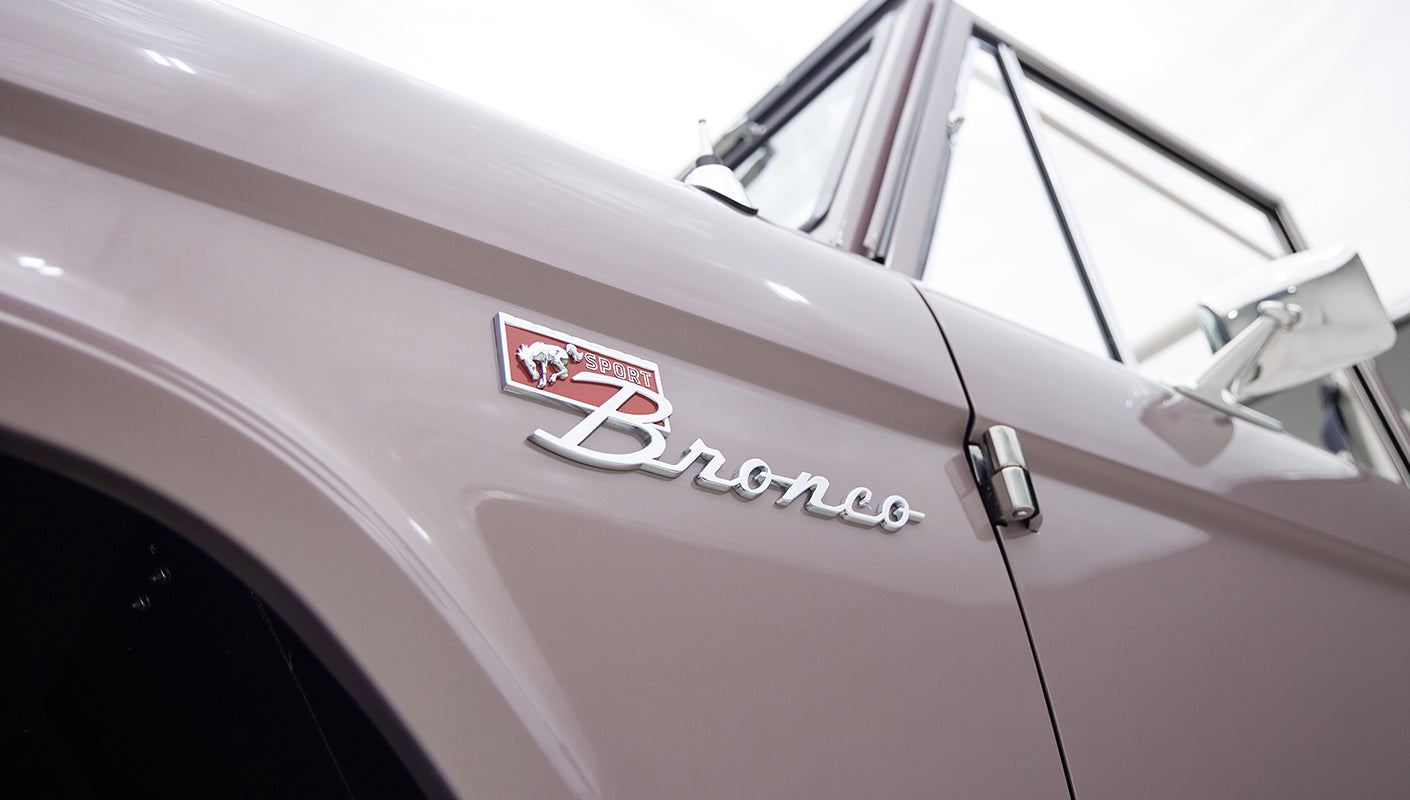 Close-up side view of Classic Ford Bronco showing Sport Bronco emblem on front fender