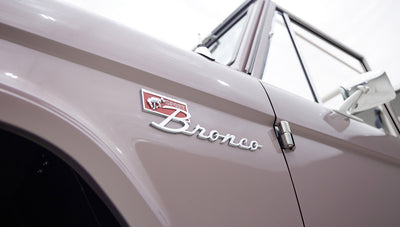 Close-up side view of Classic Ford Bronco showing Sport Bronco emblem on front fender