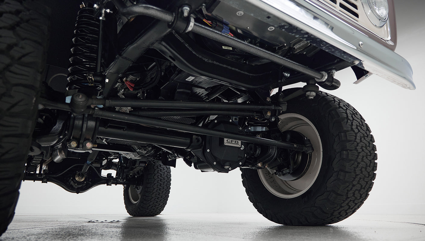 Underside view of suspension and front tires of Classic Ford Bronco