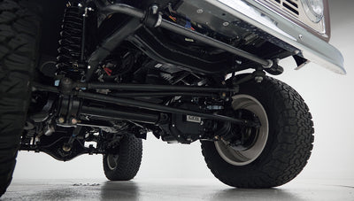 Underside view of suspension and front tires of Classic Ford Bronco