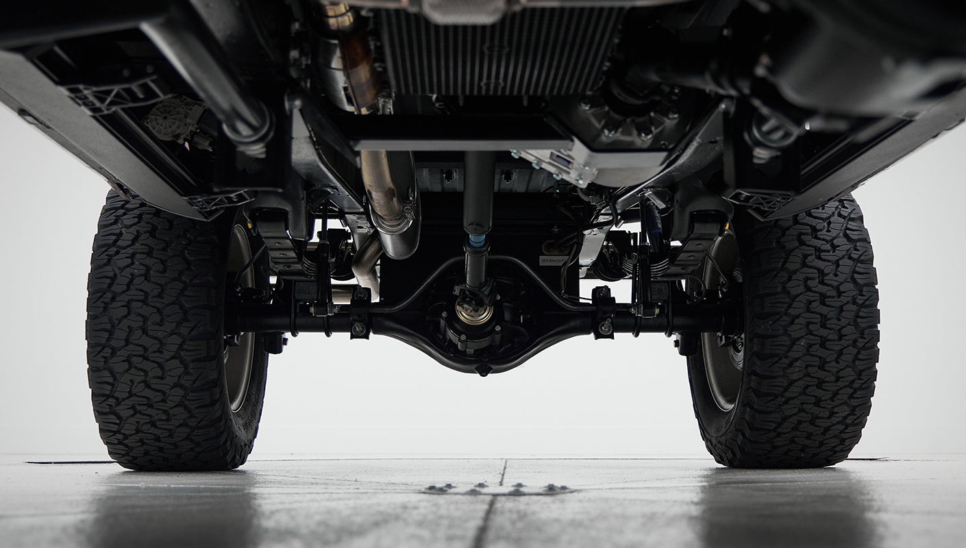 View of rear axle and differential under Classic Ford Bronco with tires