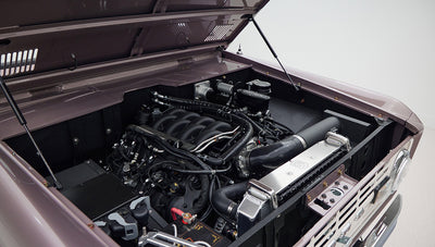 Open hood showing engine and components of Classic Ford Bronco