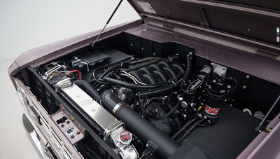 Side angled view of engine and radiator inside Classic Ford Bronco