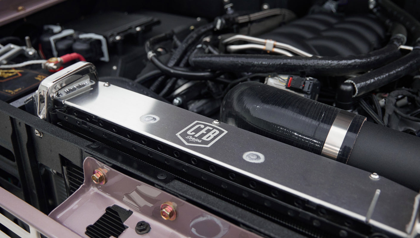 Close-up on polished radiator and hose inside Classic Ford Bronco engine bay