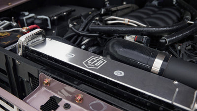 Close-up on polished radiator and hose inside Classic Ford Bronco engine bay
