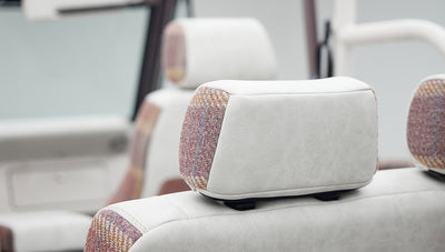 Two white headrests with patterned fabric inserts inside Classic Ford Bronco