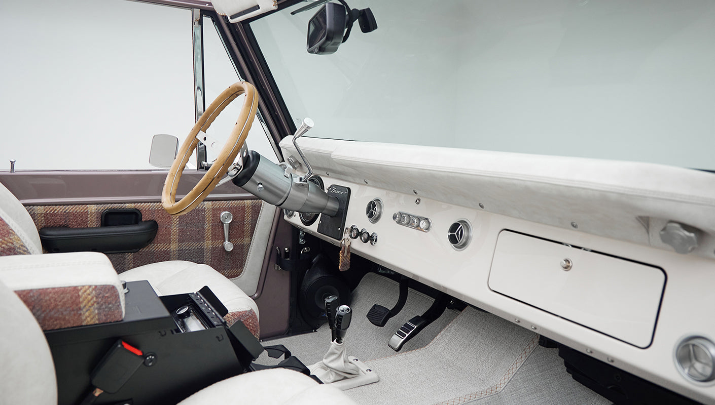 Close-up of Classic Ford Bronco dashboard controls with ignition keys and air vents