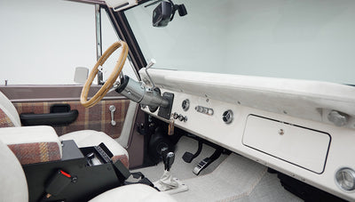 Close-up of Classic Ford Bronco dashboard controls with ignition keys and air vents