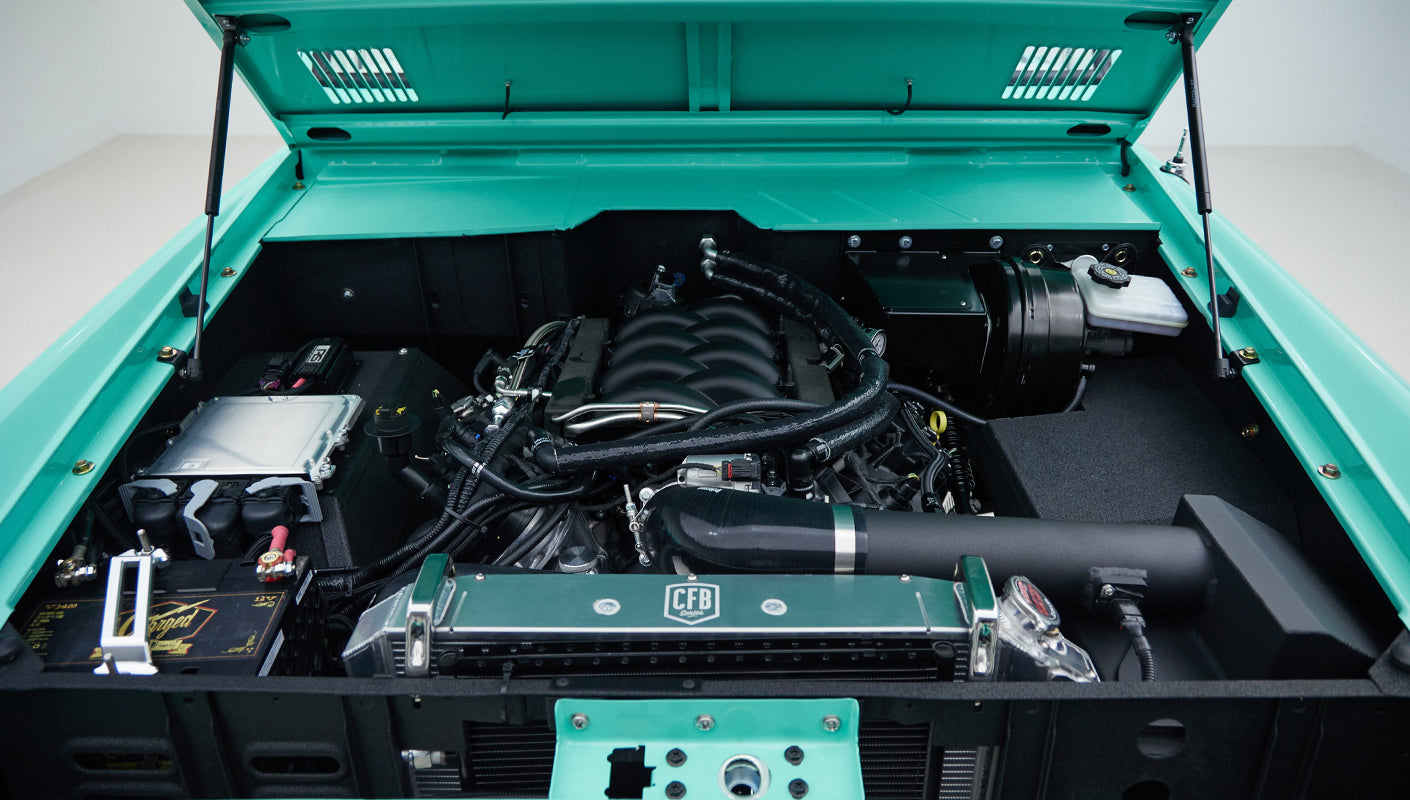 Engine bay with detailed view of engine, radiator, and other components in Classic Ford Bronco