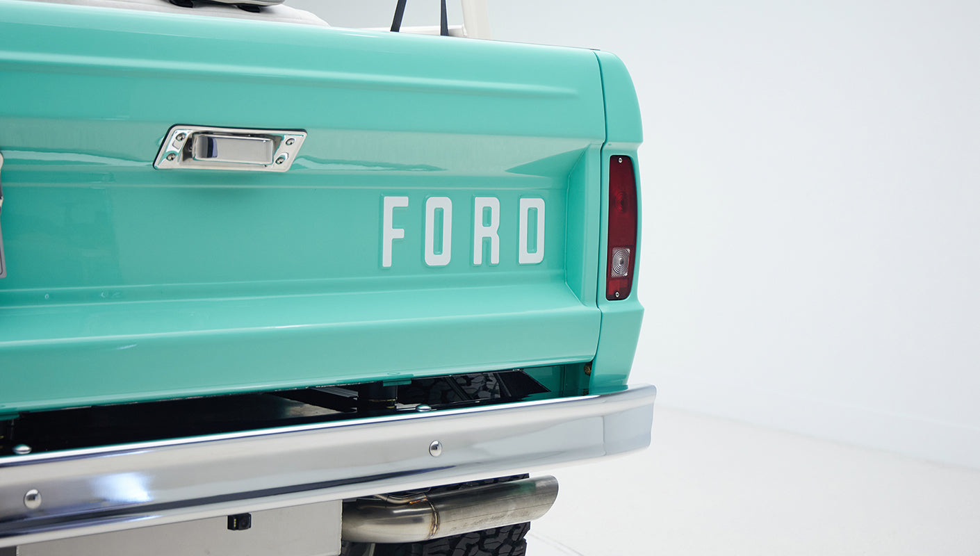 Rear tailgate of Classic Ford Bronco painted in mint green with large FORD lettering