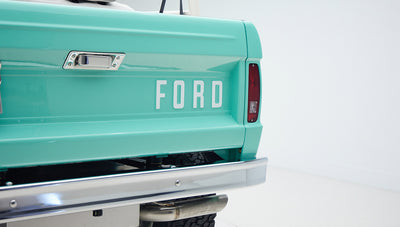 Rear tailgate of Classic Ford Bronco painted in mint green with large FORD lettering