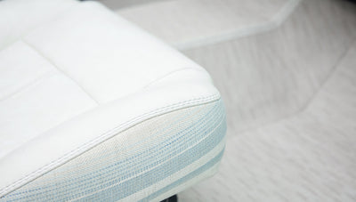Close-up of white and light blue patterned seat upholstery in classic Ford Bronco