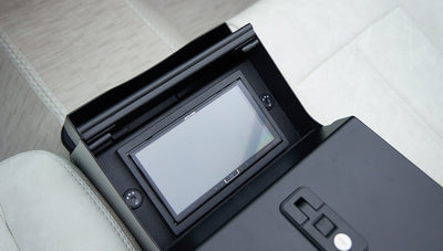 Close-up of Alpine touchscreen head unit inside the center console of a Classic Ford Bronco