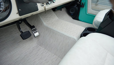 Passenger footwell area with pedals and part of the Classic Ford Bronco's dashboard and door panel