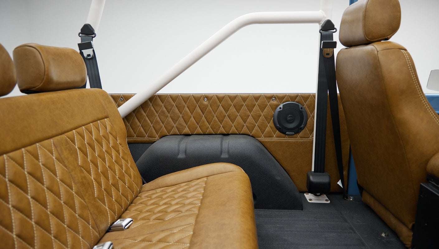 1974 classic ford bronco in stars & stripes blue with whiskey leather rear panel