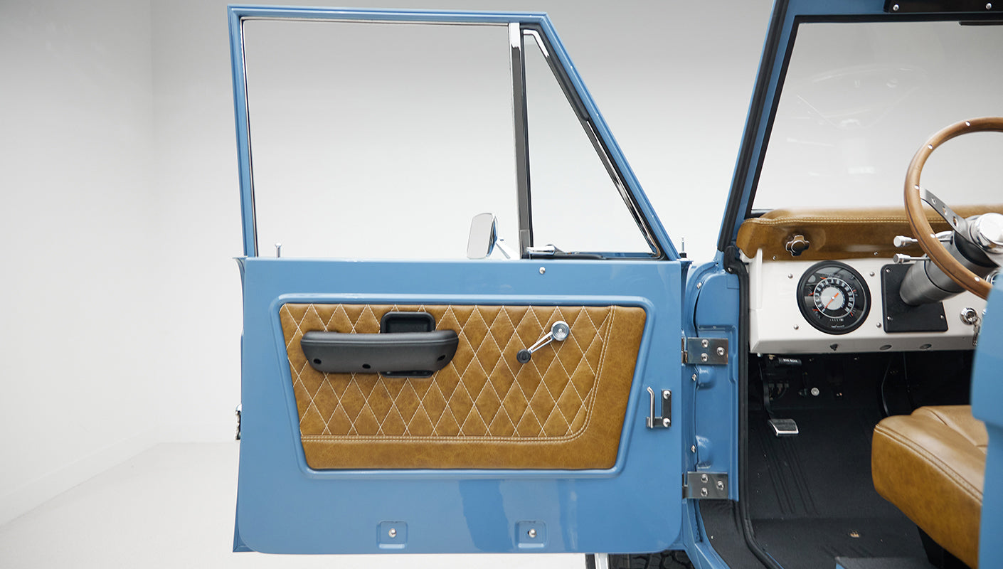 1974 classic ford bronco in stars & stripes blue with whiskey leather door panel