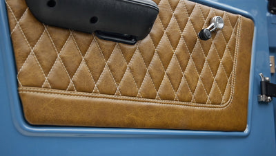 1974 classic ford bronco in stars & stripes blue with whiskey leather door panel