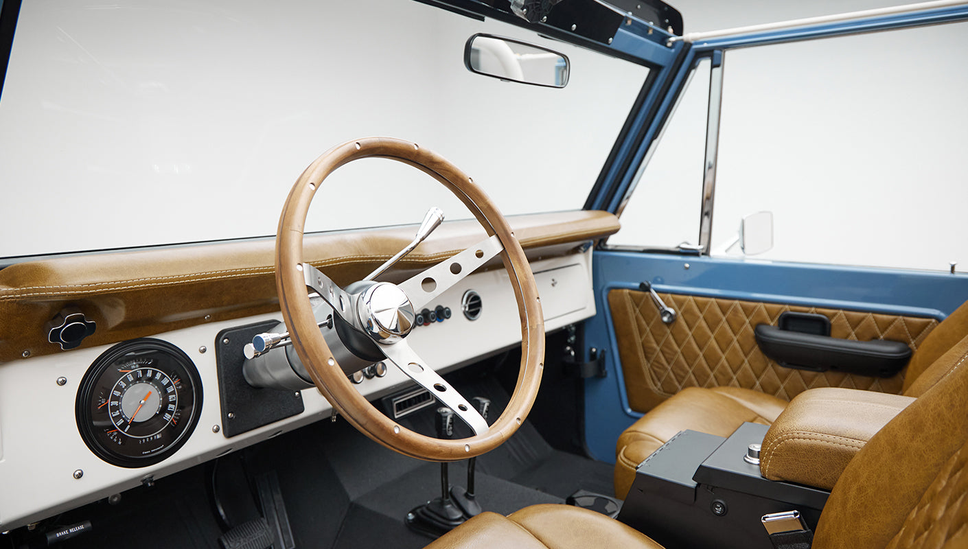 1974 classic ford bronco in stars & stripes blue with whiskey leather driver dash