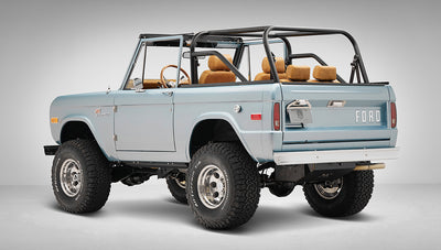 1975 ford bronco painted brittany blue with cowboy debossed, baseball stitch leather rear driver angle