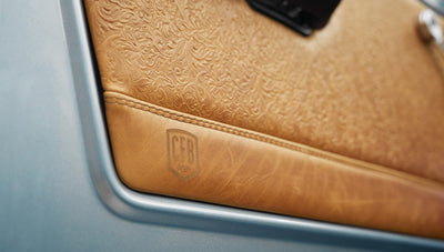 1975 ford bronco painted brittany blue with cowboy debossed, baseball stitch leather detail door panel