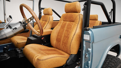 1975 ford bronco painted brittany blue with cowboy debossed, baseball stitch leather driver seat