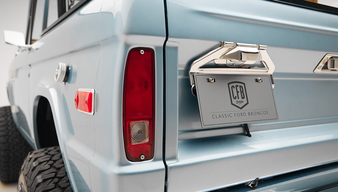 1975 ford bronco painted brittany blue with cowboy debossed, baseball stitch leather rear angle