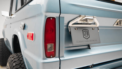 1975 ford bronco painted brittany blue with cowboy debossed, baseball stitch leather rear angle