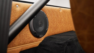 1975 ford bronco painted brittany blue with cowboy debossed, baseball stitch leather rear speaker