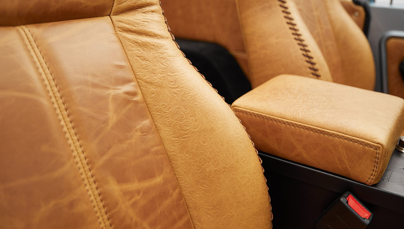 1975 ford bronco painted brittany blue with cowboy debossed, baseball stitch leather seat detail