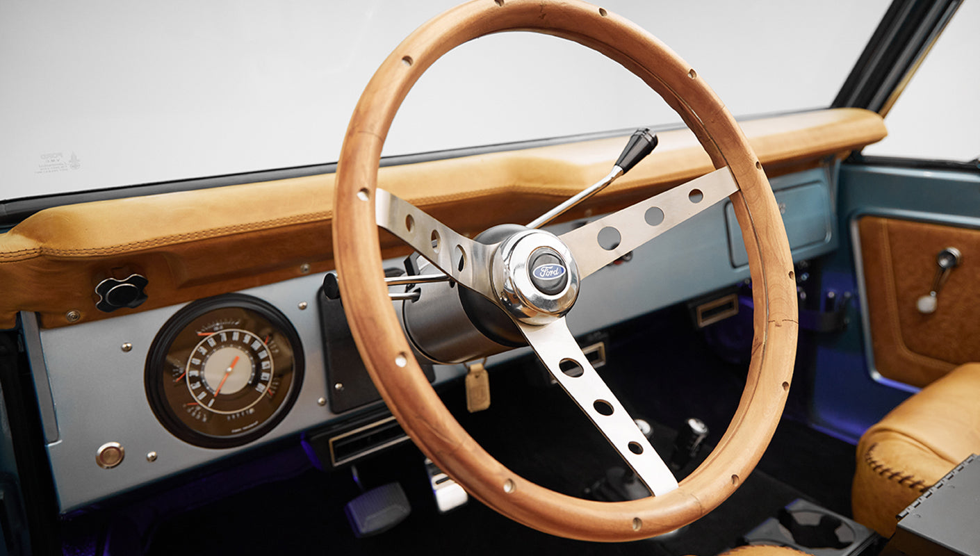 1975 ford bronco painted brittany blue with cowboy debossed, baseball stitch leather steering wheel