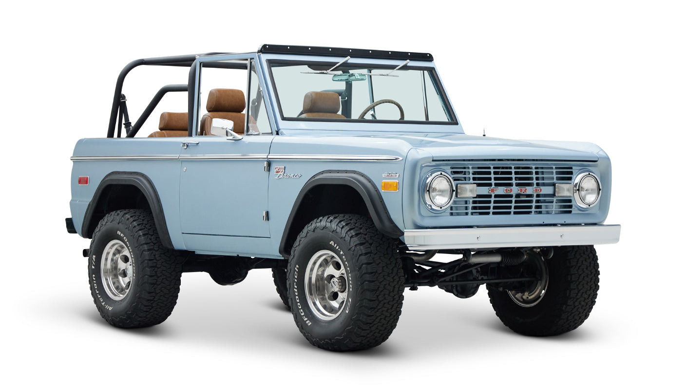 Classic Ford Bronco in Brittany Blue, front angled view showing chrome details and tires