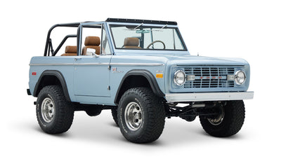 Classic Ford Bronco in Brittany Blue, front angled view showing chrome details and tires