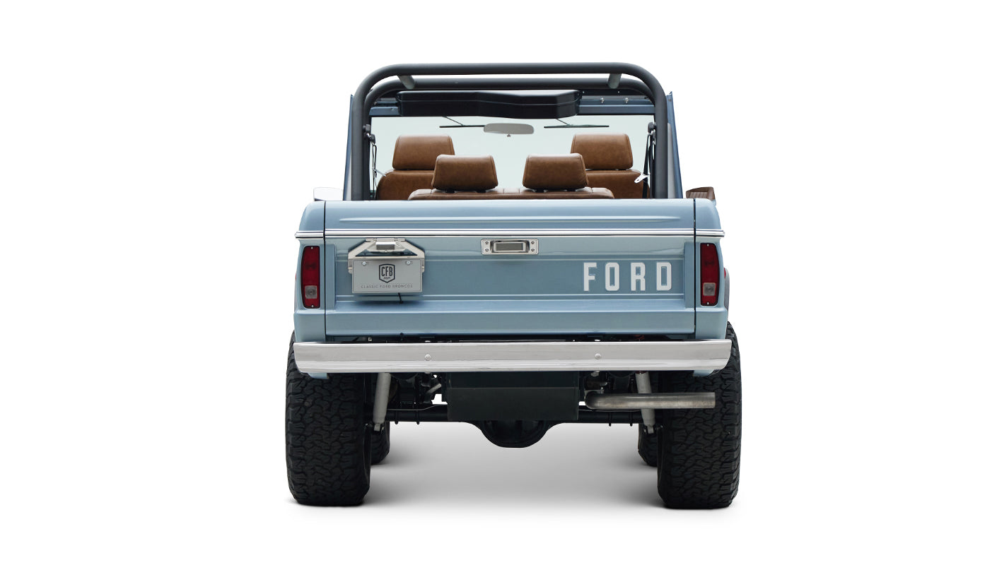 Rear view of Classic Ford Bronco in light blue with visible tailgate and spare tire mount