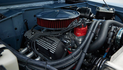 Close-up of 'Bronco Powered by Ford' valve cover and engine components in Brittany Blue Classic Ford Bronco