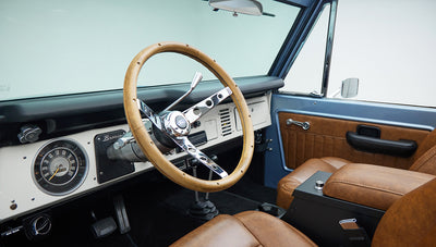 Classic Ford Bronco 1976 Brittany Blue with tan interior and chrome-trimmed steering wheel