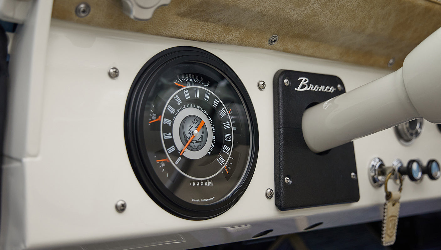 A 1976 Classic Ford Bronco is Frozen Blue over White Rock leather with custom grateful dead gauge