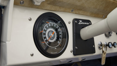 A 1976 Classic Ford Bronco is Frozen Blue over White Rock leather with custom grateful dead gauge