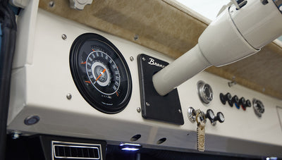 A 1976 Classic Ford Bronco is Frozen Blue over White Rock leather with custom grateful dead gauge