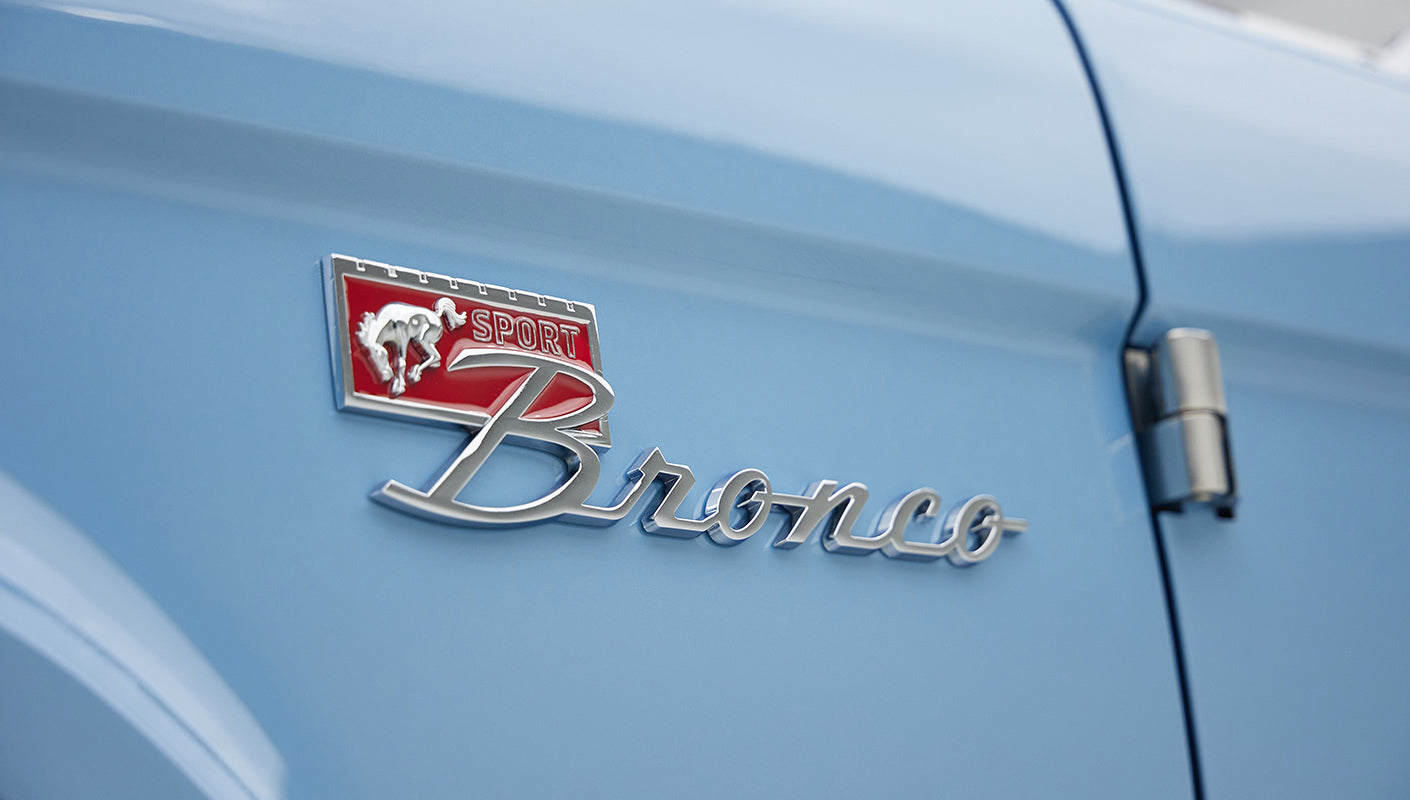 A 1976 Classic Ford Bronco is Frozen Blue over White Rock leather emblem