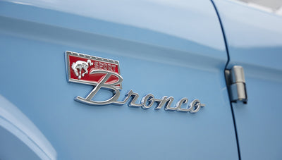 A 1976 Classic Ford Bronco is Frozen Blue over White Rock leather emblem
