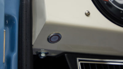 A 1976 Classic Ford Bronco is Frozen Blue over White Rock leather electronic parking brake