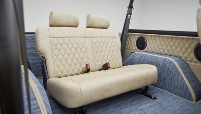 A 1976 Classic Ford Bronco is Frozen Blue over White Rock leather rear seat