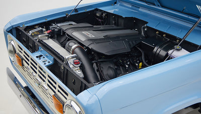 A 1976 Classic Ford Bronco is Frozen Blue over White Rock leather ford coyote motor