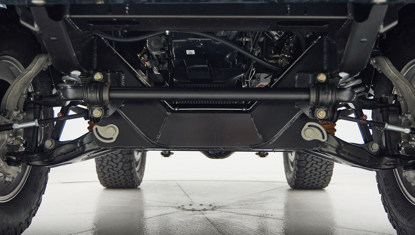 A 1976 Classic Ford Bronco is Frozen Blue over White Rock leather roadster shop chassis independent suspension
