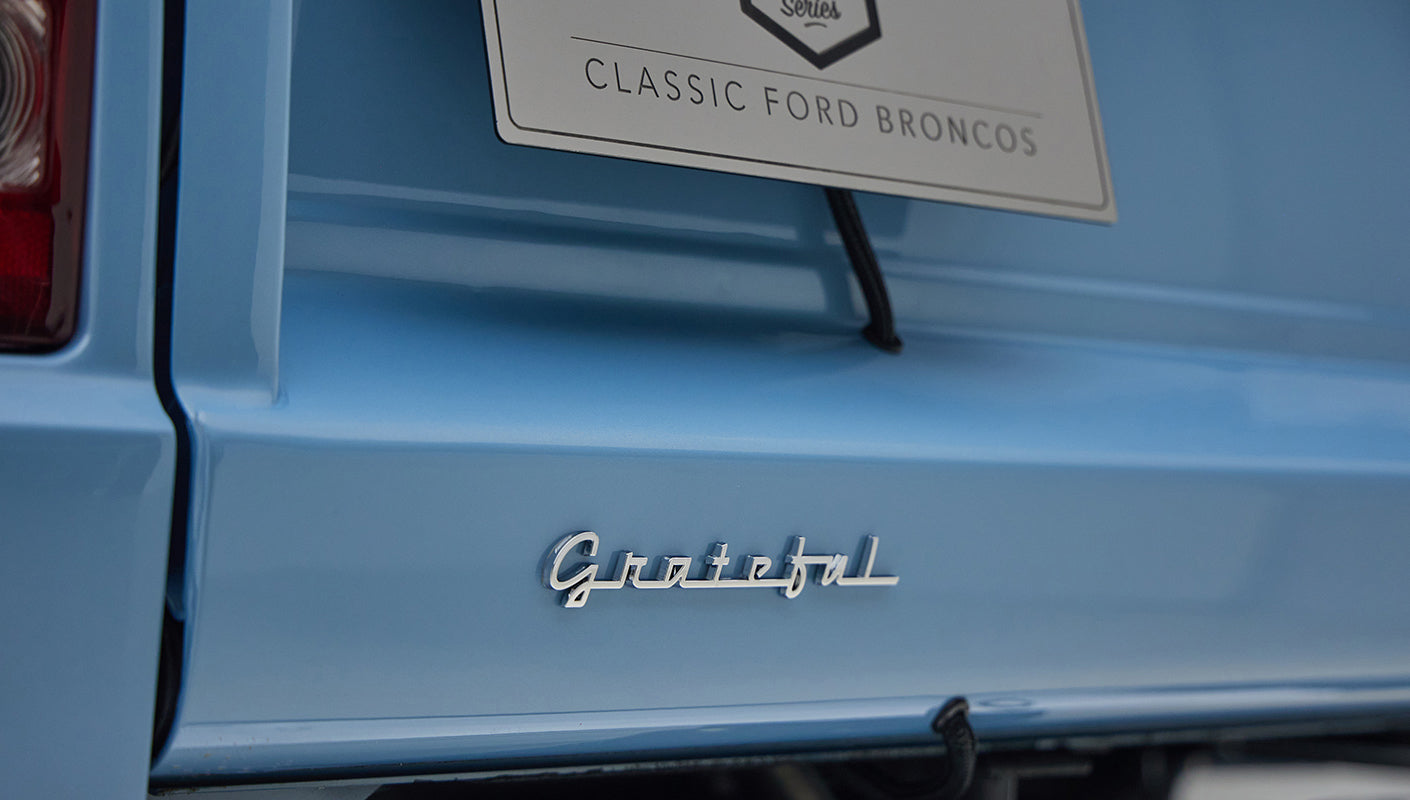 A 1976 Classic Ford Bronco is Frozen Blue over White Rock leather custom grateful dead badge