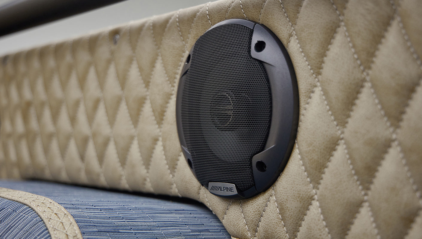 A 1976 Classic Ford Bronco is Frozen Blue over White Rock leather rear speaker