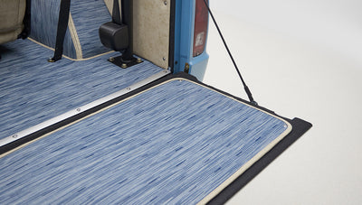 A 1976 Classic Ford Bronco is Frozen Blue over White Rock leather tailgate custom carpet kit
