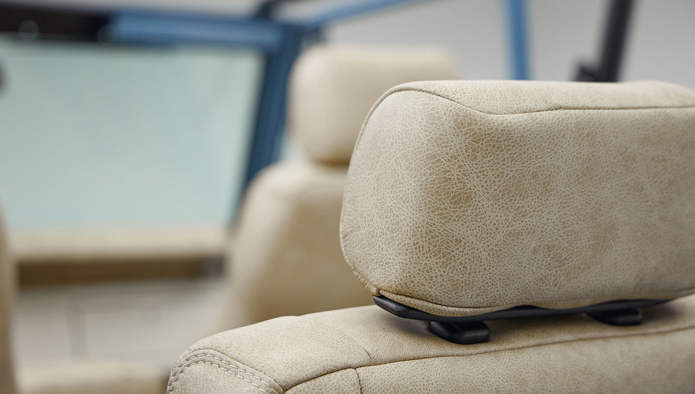 A 1976 Classic Ford Bronco is Frozen Blue over White Rock leather headrests