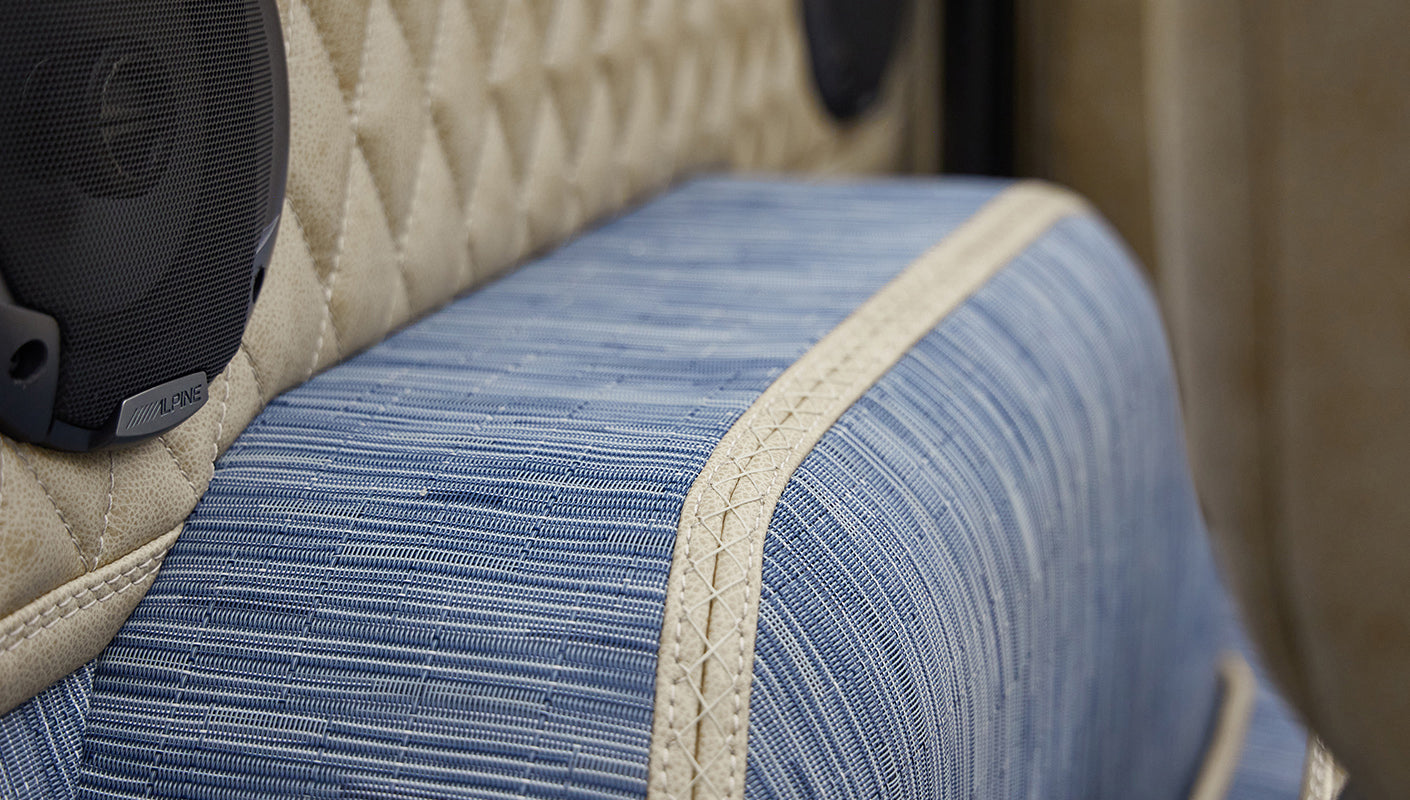 A 1976 Classic Ford Bronco is Frozen Blue over White Rock leather custom carpet kit wheelwell