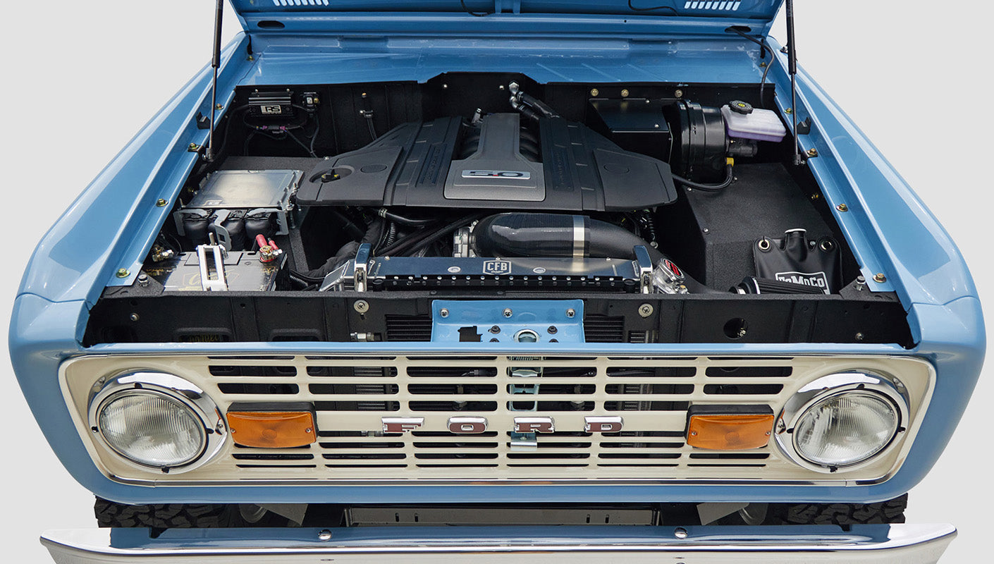 A 1976 Classic Ford Bronco is Frozen Blue over White Rock leather ford coyote motor